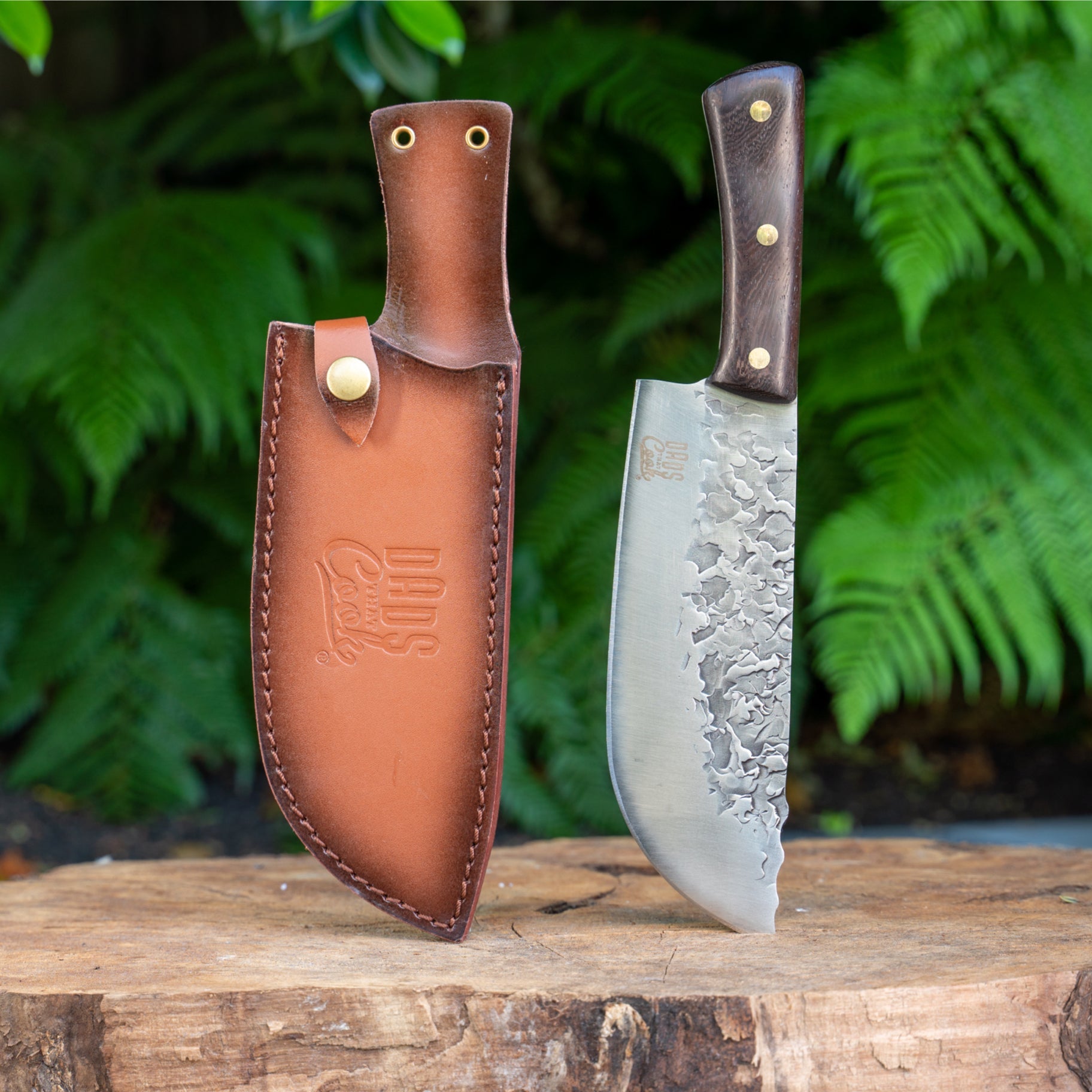 Stainless BBQ knife with wood handle in a brown leather sheath