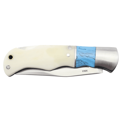 Folding knife with bone white handle and blue inlay, stainless blade visible
