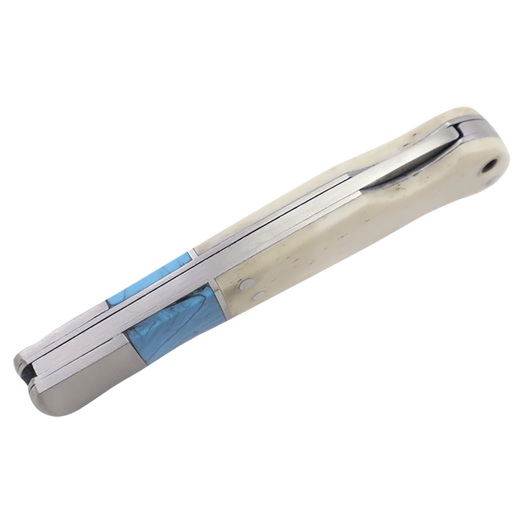 Folding knife with bone white handle and blue inlay, close-up side view