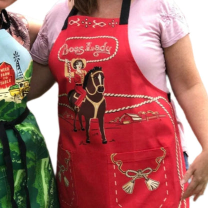 Red western BBQ apron worn with Boss Lady logo, cowgirl on horse, front pocket