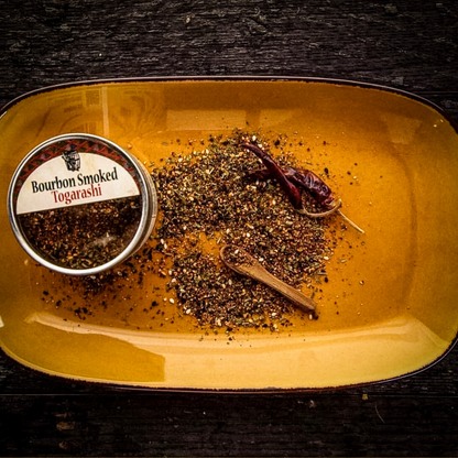 Bourbon smoked togarashi seasoning tin with spice blend and chili on tray
