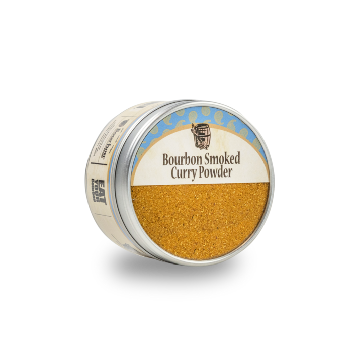 Bourbon smoked curry powder jar, gold-brown powder filling the open lid