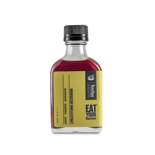 Vanilla extract bottle with dark cap, amber-burgundy liquid, and front label