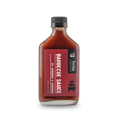 Barbecue sauce bottle with bourbon and sorghum label, dark red sauce