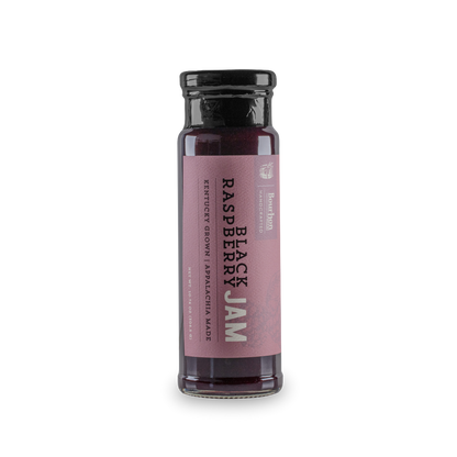 Black raspberry jam bottle with pink label and dark purple berry filling