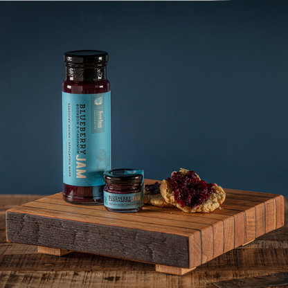 Blueberry cardamom jam jar with black lid and dark purple filling, small jar and jam scone.
