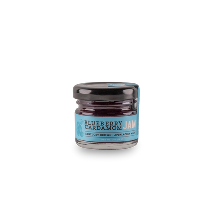 Blueberry cardamom jam jar with black lid, dark purple filling, blue label.