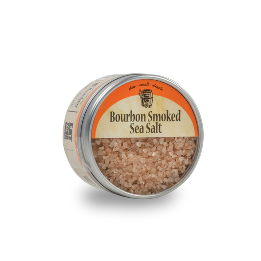 Bourbon smoked sea salt tin, lid-up with coarse pink salt visible