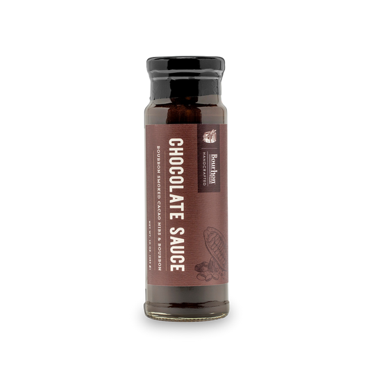 Bourbon-smoked cacao nib chocolate sauce bottle with dark amber liquid