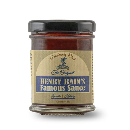 Small Henry Bain's famous sauce jar with amber sauce and black lid