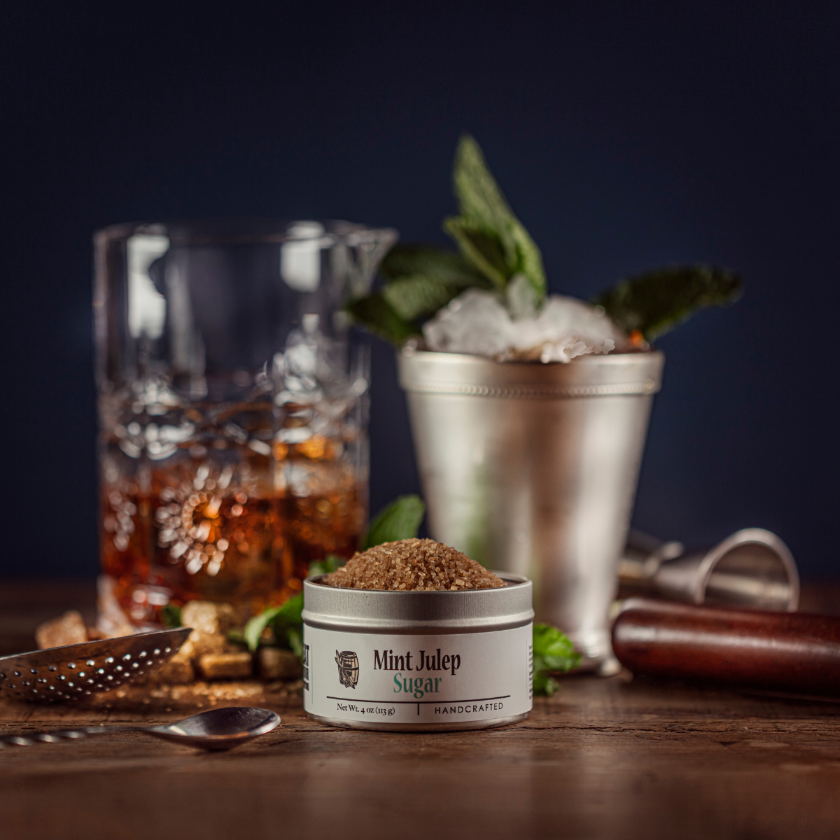 Small metal sugar container with granulated sugar top and front label