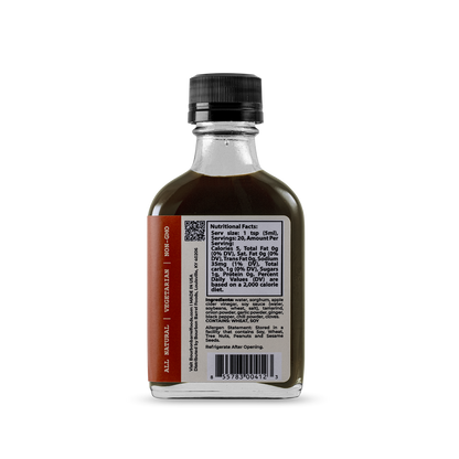 Worcestershire sauce bottle with dark sauce and nutrition label panel, black ribbed cap