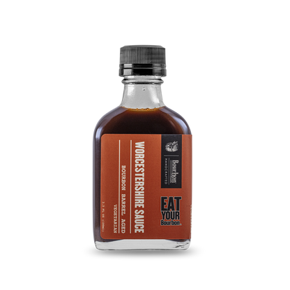 Worcestershire sauce bottle with amber-brown liquid and black ribbed cap, front label