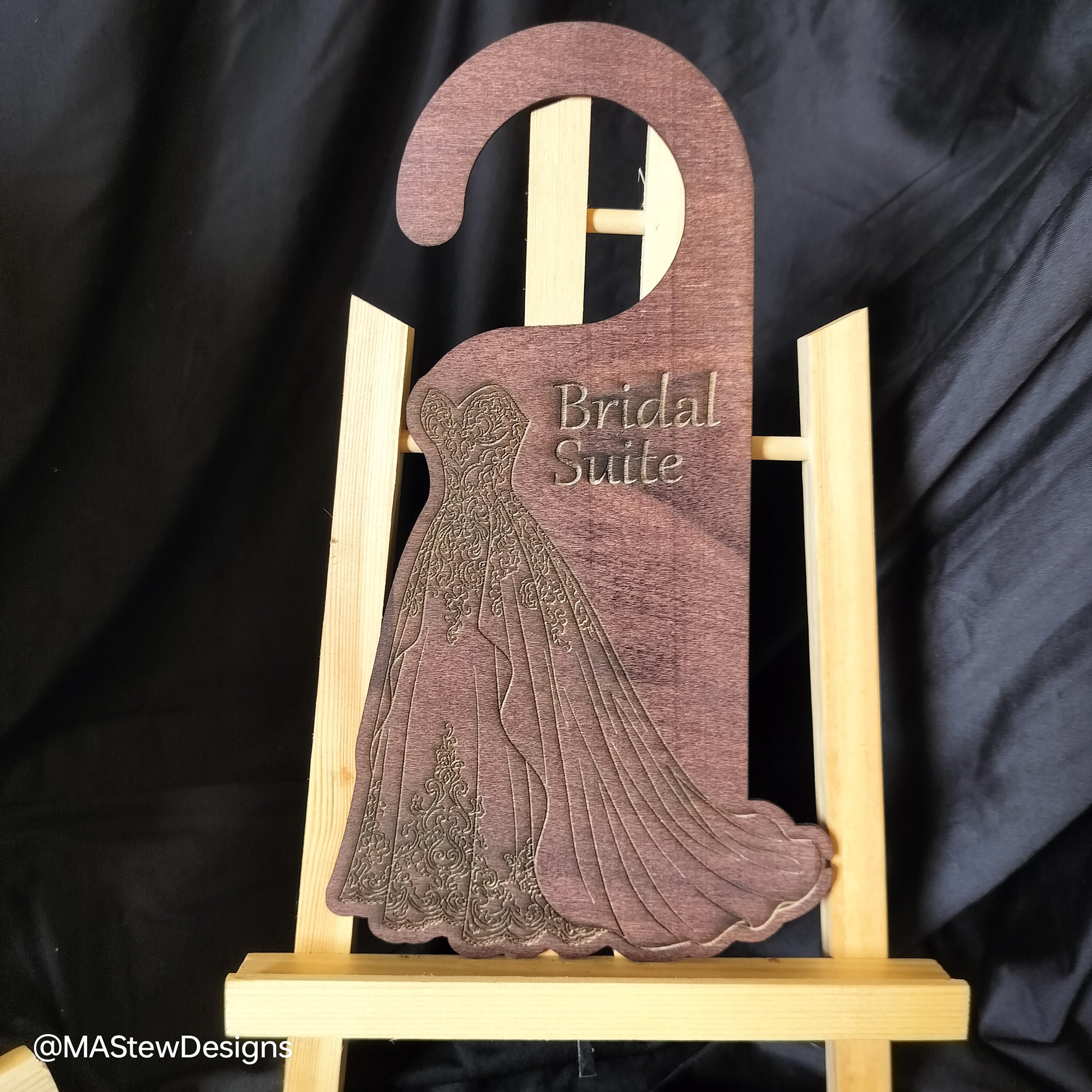 Wooden hanger with 'Bridal Suite' engraving on a black background