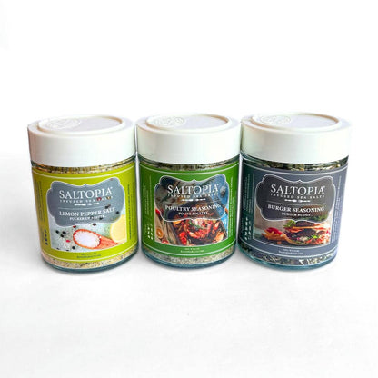 Three SALTOPIA infused sea salt jars: lemon pepper, poultry seasoning, and burger seasoning