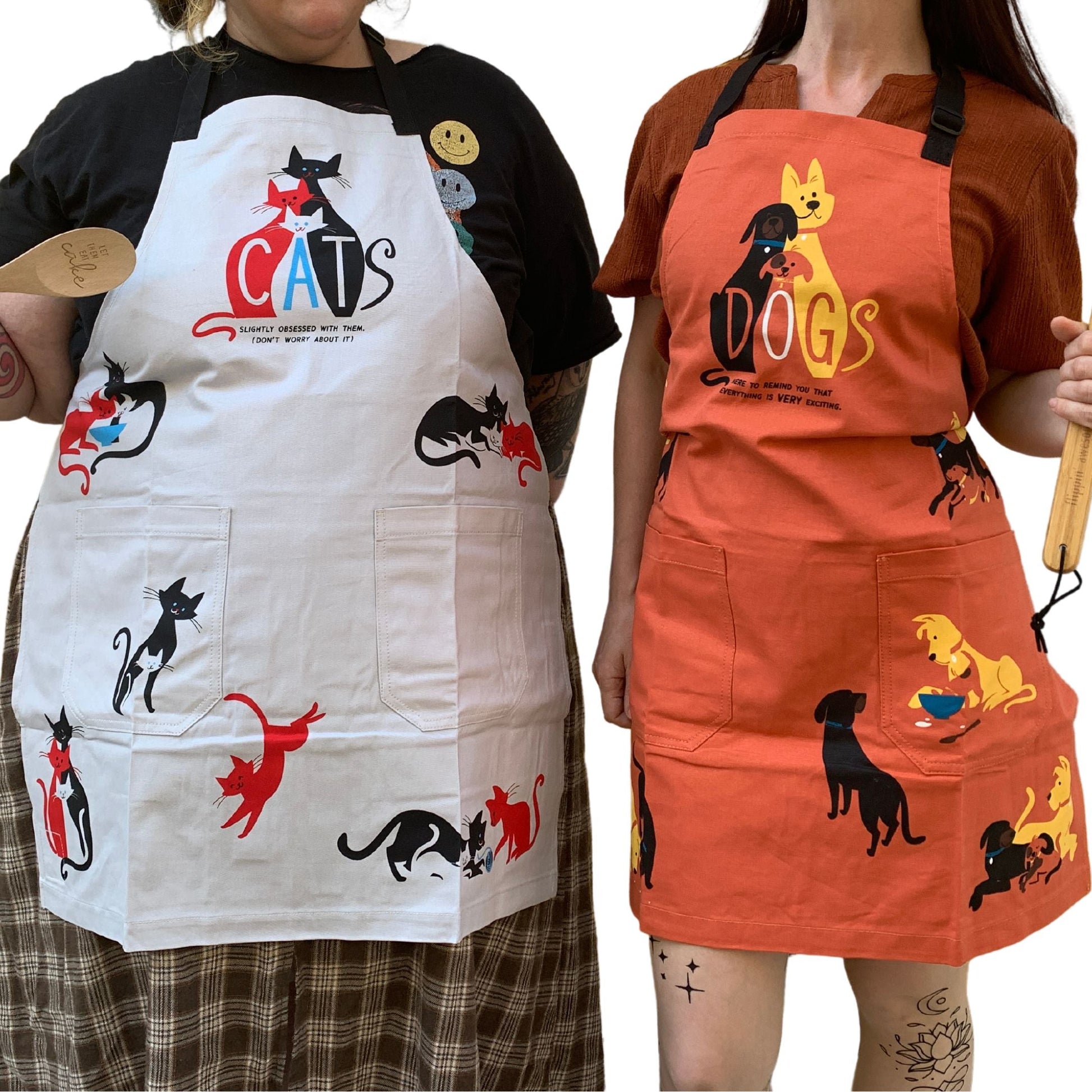 White cat cooking apron with cat and “CATS” graphics; front has two chest pockets