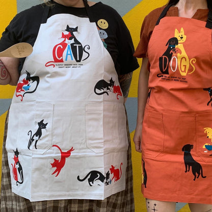 White cat cooking apron with front cat prints and “CATS” logo over two pockets