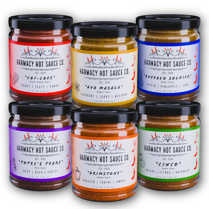 Hot sauce jar pack with six glass jars, black lids, colorful label designs