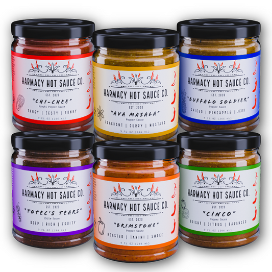 Hot sauce jar pack with six glass jars, black lids, colorful label designs