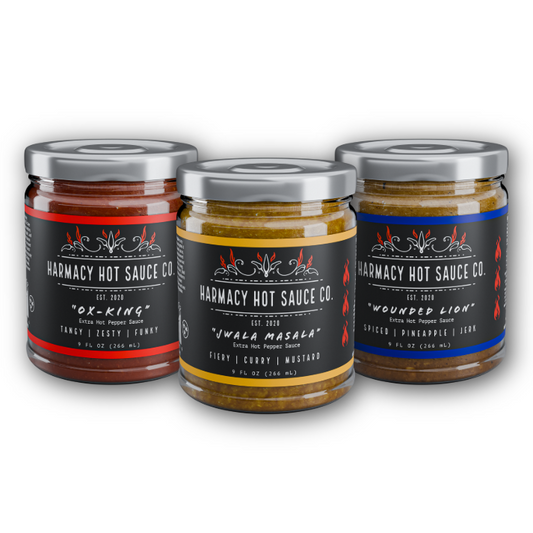 Hot sauce variety pack with three HARMACY bottles: red, amber, and blue labels
