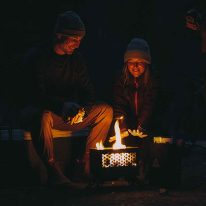 FireCan portable fire pit with visible flames in the vented front