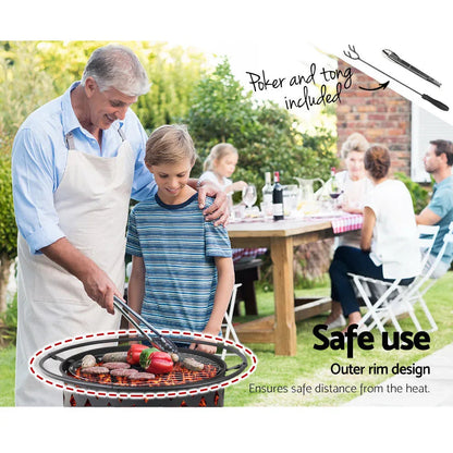 Portable fire pit BBQ grill with outer safety rim and poker tool resting near top