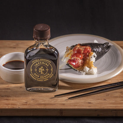 Soy sauce bottle beside plated food with dark sauce