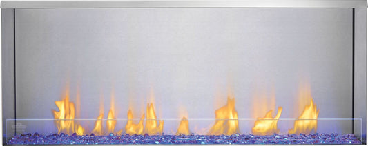Outdoor gas fireplace with stainless steel surround and glowing flames on blue glass bed