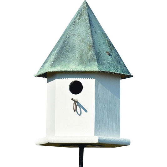 White octagonal bird house with green verdigris copper roof and round entrance hole