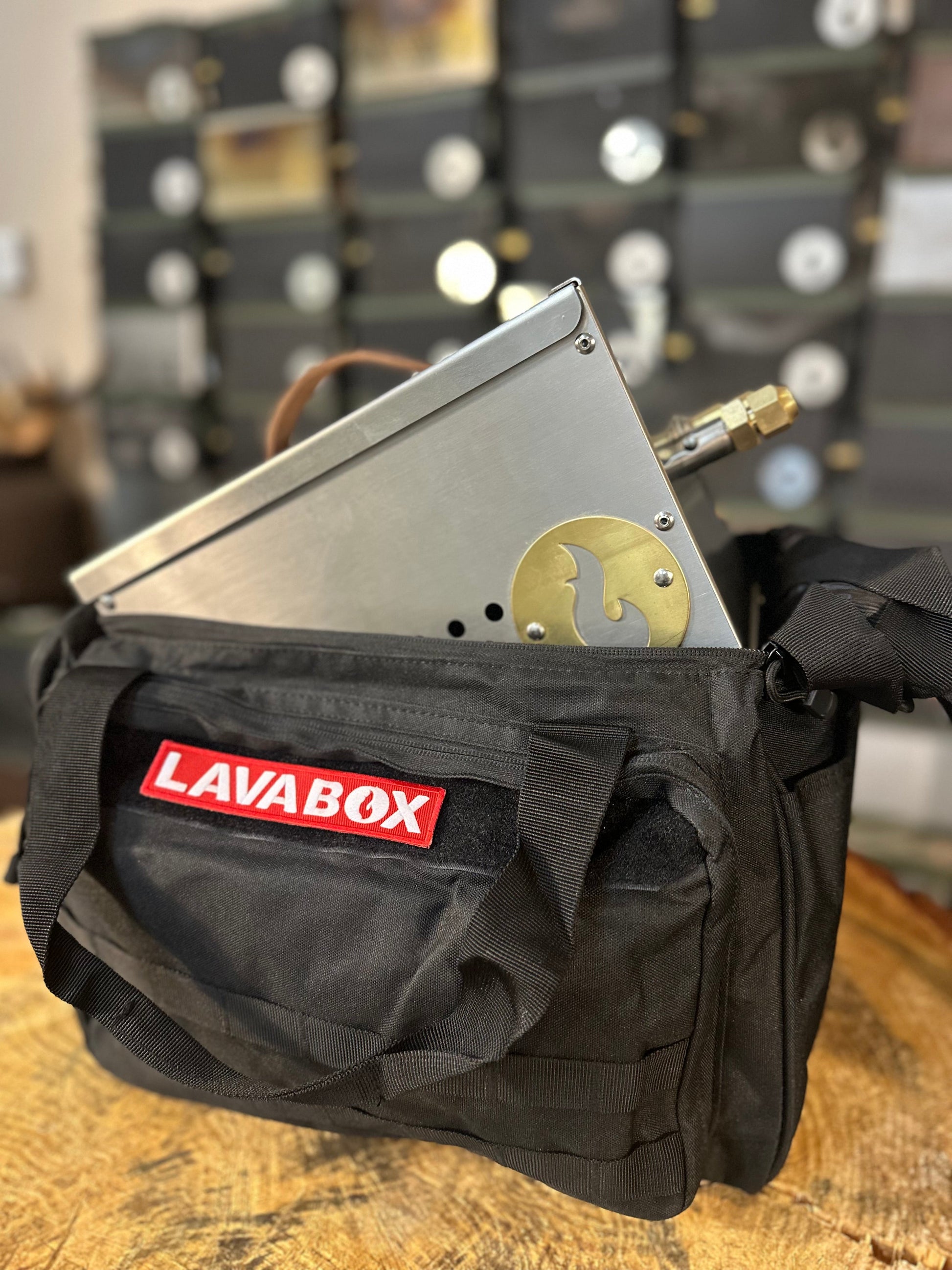 Black storage bag with flame emblem patch, carry handles, and front zipper pocket