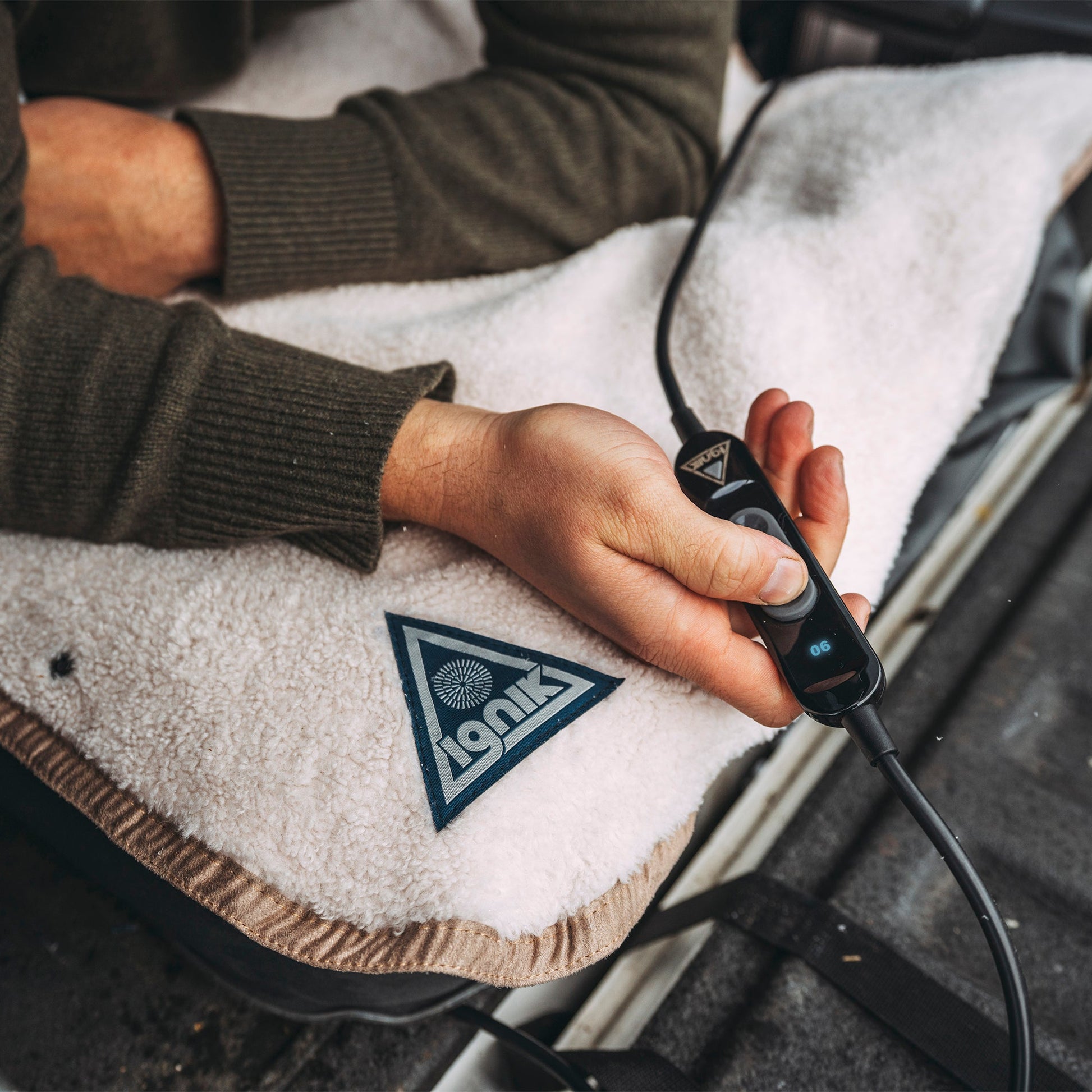 Heated fleece bed cover with controller plug connected near the power cord