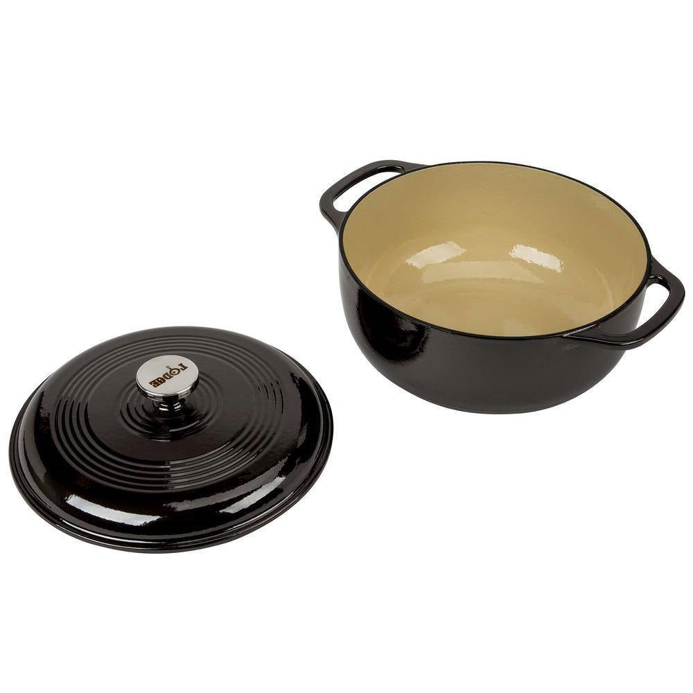 Black enamel cast iron Dutch oven with beige interior and matching lid, side handles