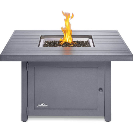Square outdoor fire table with grey cabinet and visible flames in center burner
