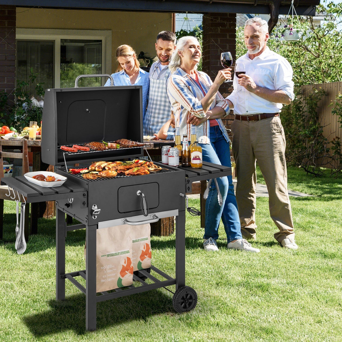Charcoal grill with open lid and front control panel, side shelves, and caster wheels