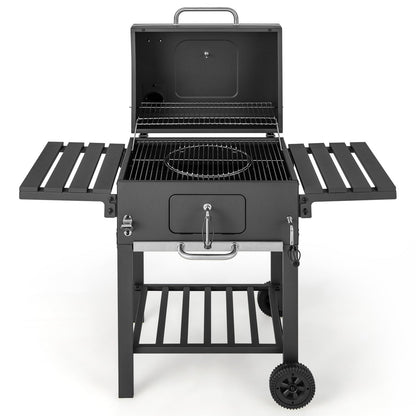 Open-lid charcoal grill with wire cooking grates and foldable side tables on wheels