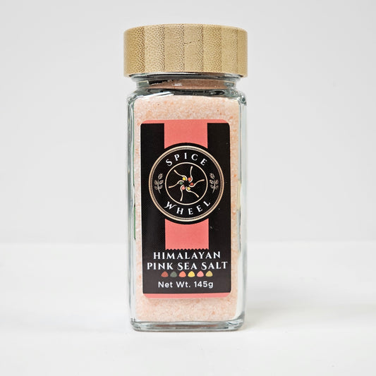Pink sea salt in glass jar with cork lid and Spice Wheel label