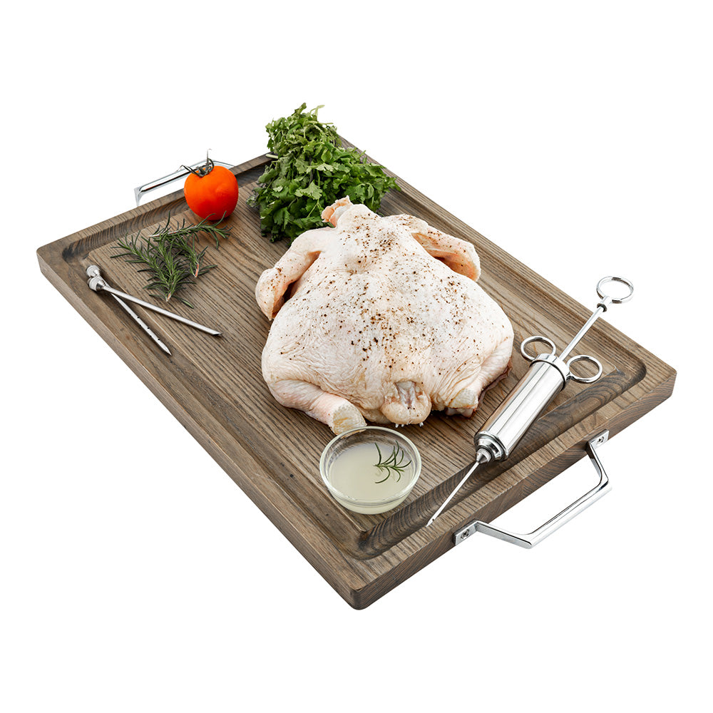 Stainless meat injector kit with injector tool, needles, and marinade dish on tray