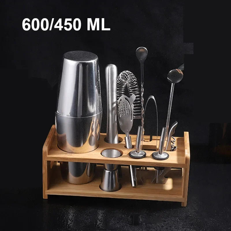 Stainless cocktail shaker and bar tools arranged on a wooden organizer