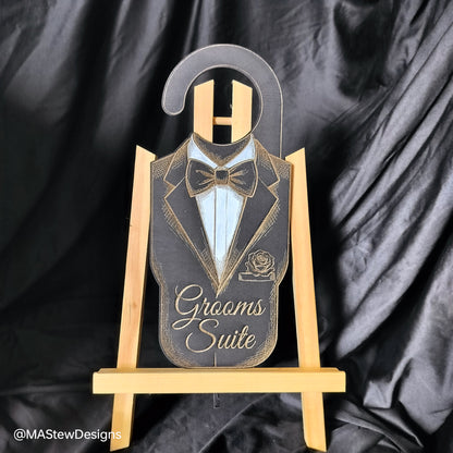 Decorative sign with tuxedo design on a wooden stand against a black satin background