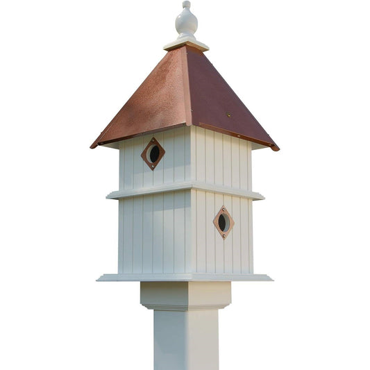 Two-story white birdhouse with copper roof and two diamond entrance openings