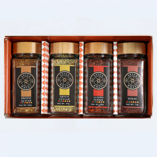Four spice jars with paper labels in a wooden gift tray: Brown, Green, Aleppo, Sumac