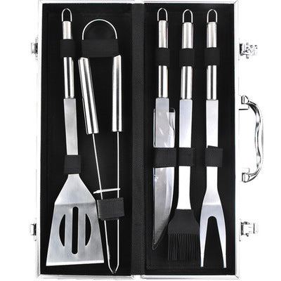 BBQ grill tool set in open aluminum case with stainless spatula, tongs, and grilling forks