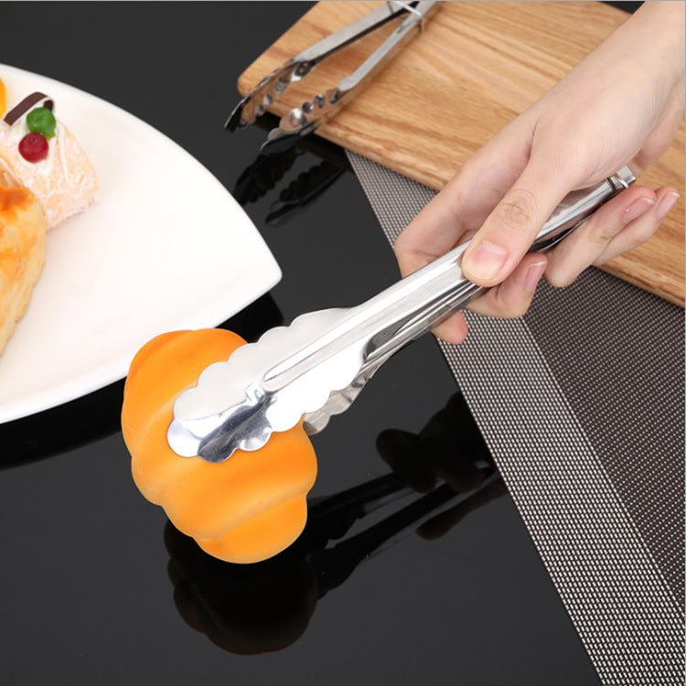 Stainless steel BBQ steak tongs held with orange silicone grip