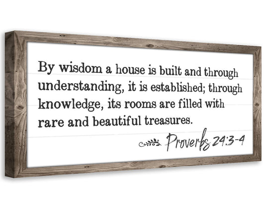 Wood-framed canvas wall art with Proverbs 24:3 quote in black lettering.