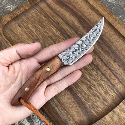 Meat scimitar knife held in hand; damascus-pattern blade and wooden handle with brass rivets