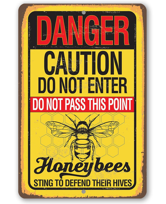Warning honeybees metal sign with red Danger and yellow Caution text, bee graphic