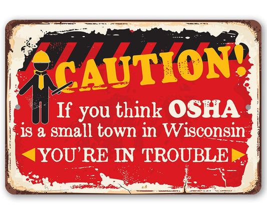 Metal warning sign with red “CAUTION!” and OSHA Wisconsin message