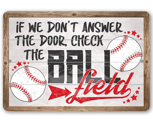 Baseball door-check metal sign with red “field” lettering and baseball graphics