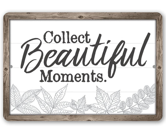 Metal sign with gray wood frame and “Collect Beautiful Moments” text plus leaf border