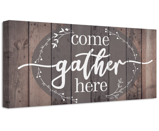Canvas wall art with “Come gather here” lettering on rustic wood-plank background.